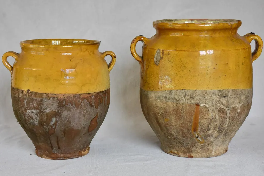 Two large antique French confit pots with yellow glaze